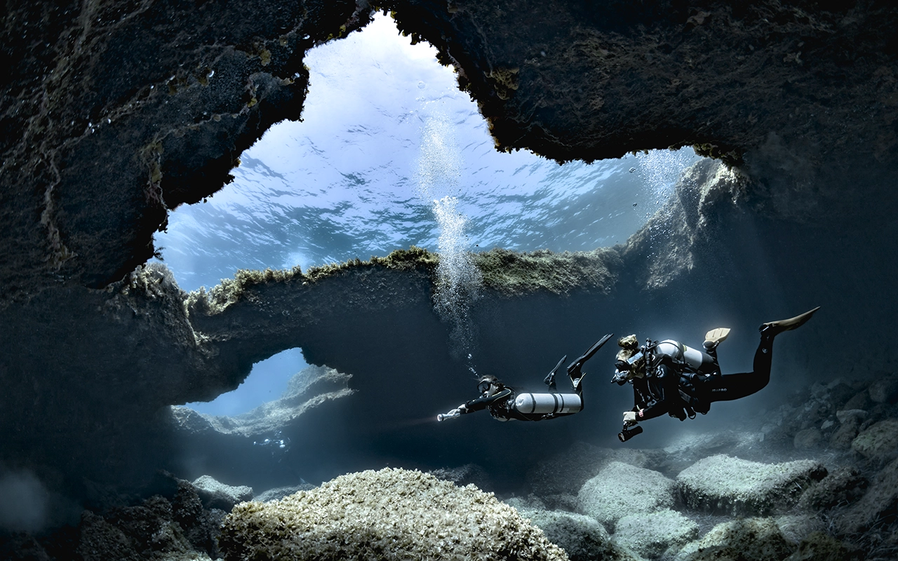 Diver exploring a Mediterranean wreck in clear water