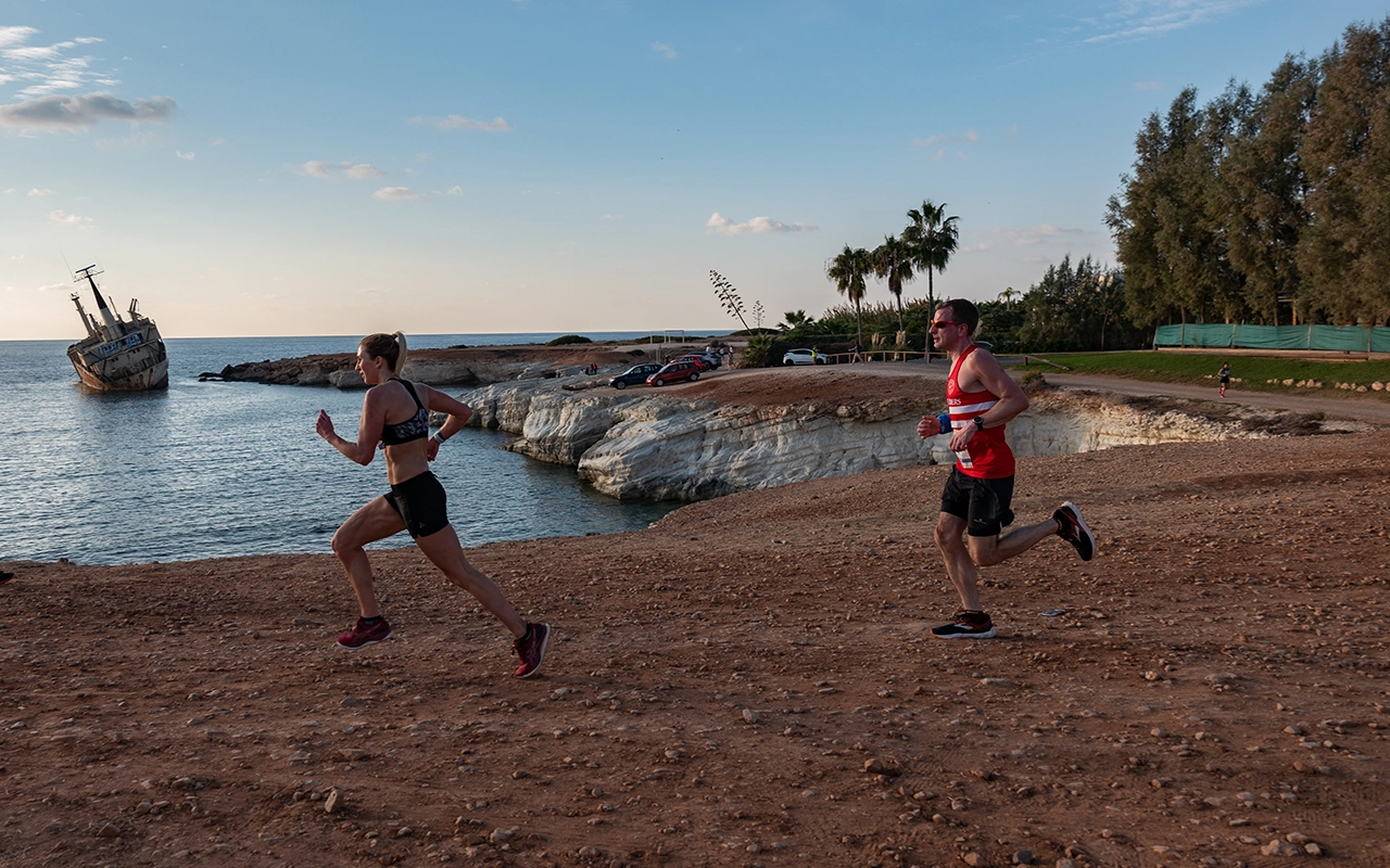 Runner on a coastal boardwalk at sunrise