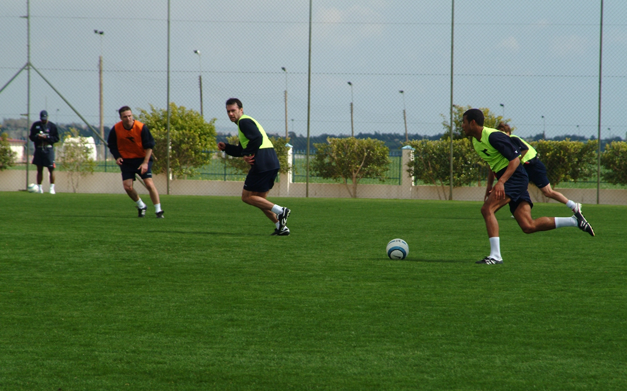 Football pitch and track under evening lights